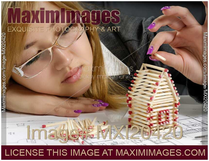Young Woman Building a House from Matches
