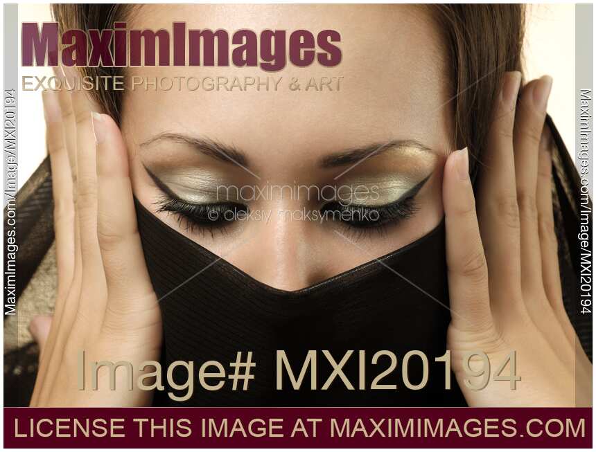 Young Woman Covering Her Face with Scarf