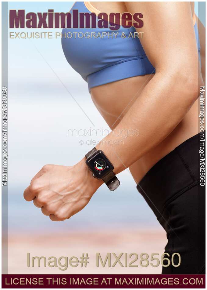 Young woman exercising outdoors wearing Apple Watch