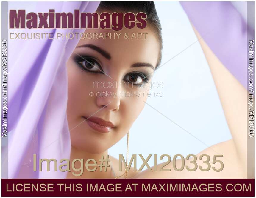 Young woman face behind curtain