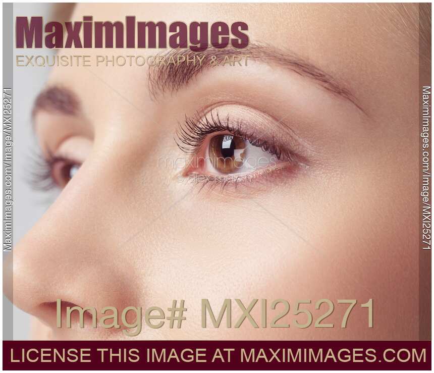 Young woman face closeup of brown eyes