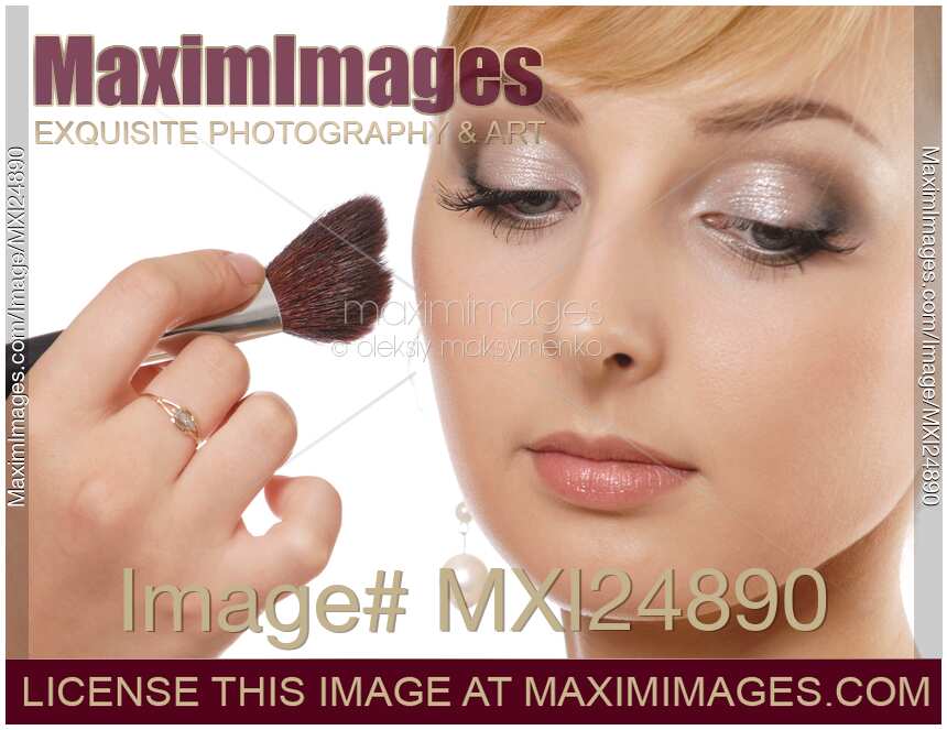 Young woman having her makeup applied