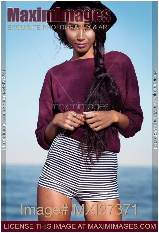 Young woman in striped shorts at the beach