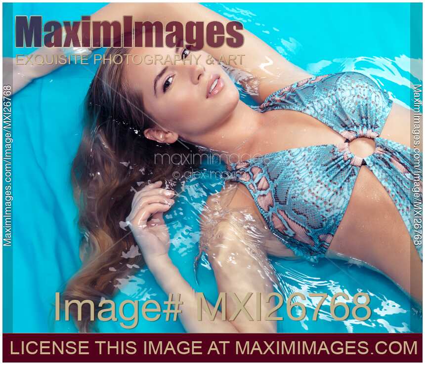 Young woman in swimsuit lying in water