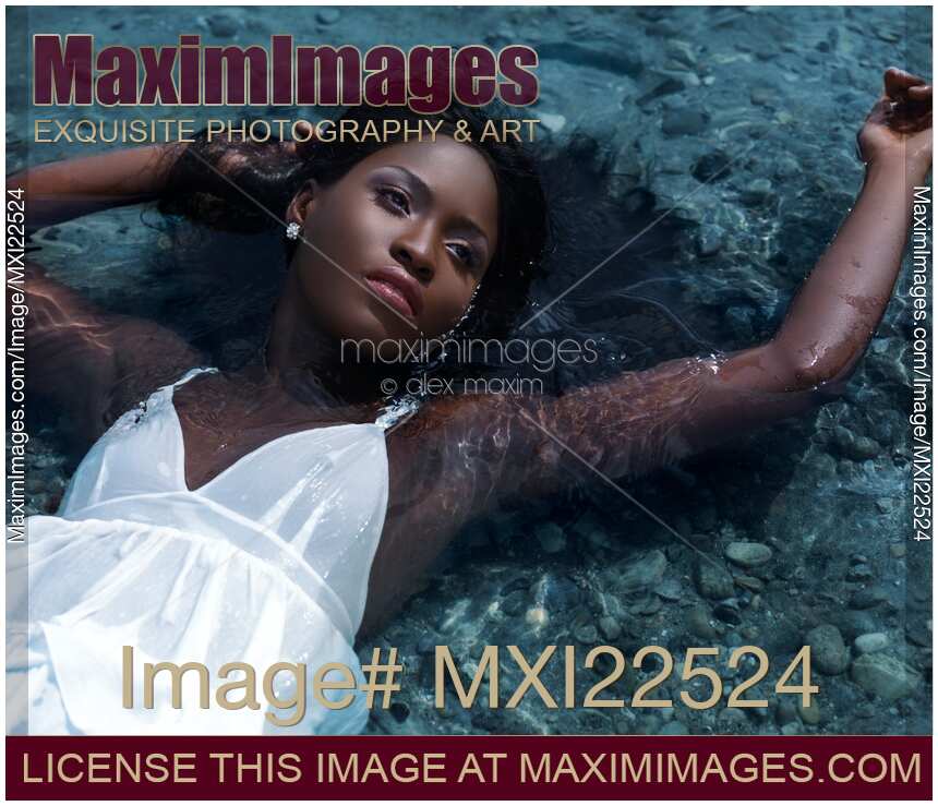 Young Woman in White Dress Lying in Water