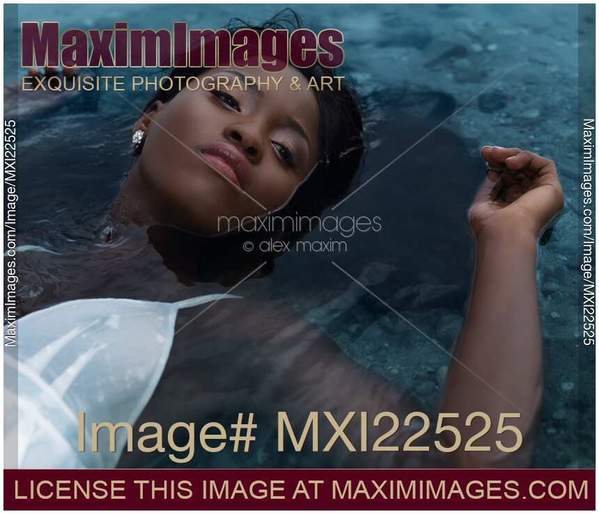 Young Woman in White Dress Lying in Water
