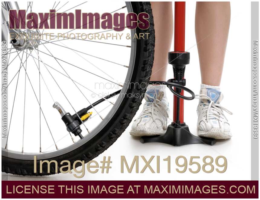 Young Woman Inflating Bicycle Tire