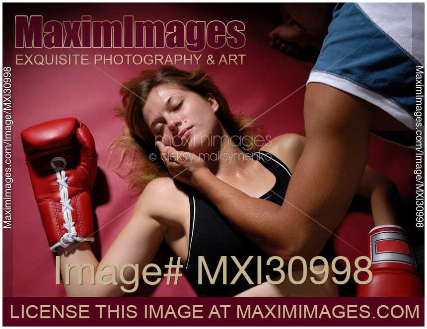 Young woman knocked out on a boxing rink