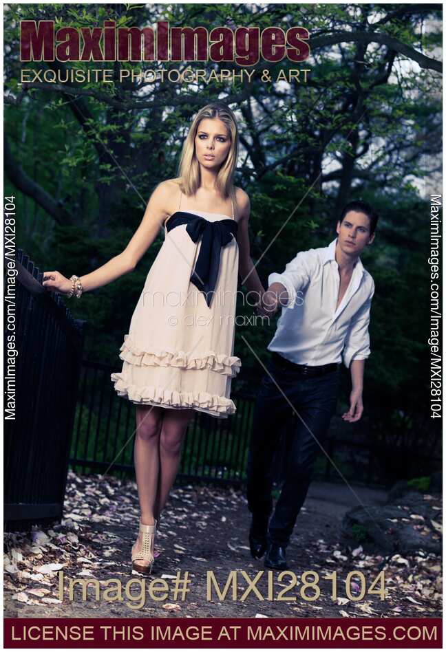 Young woman leading a man behind