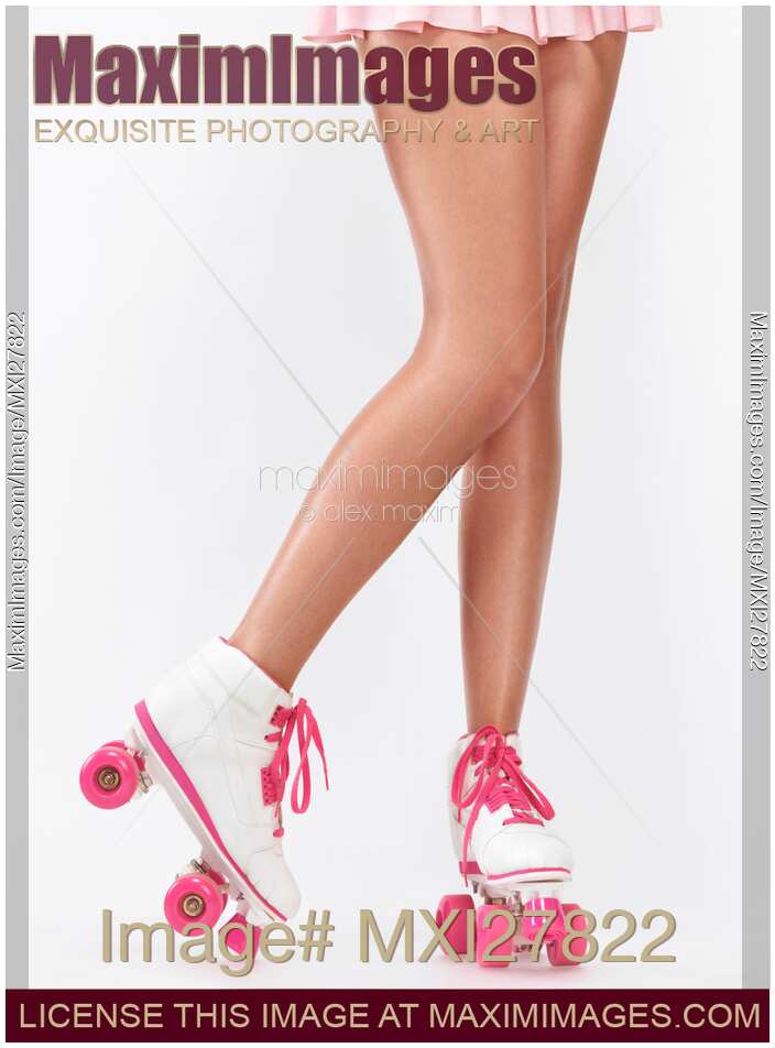 Young woman long legs in pink roller skates