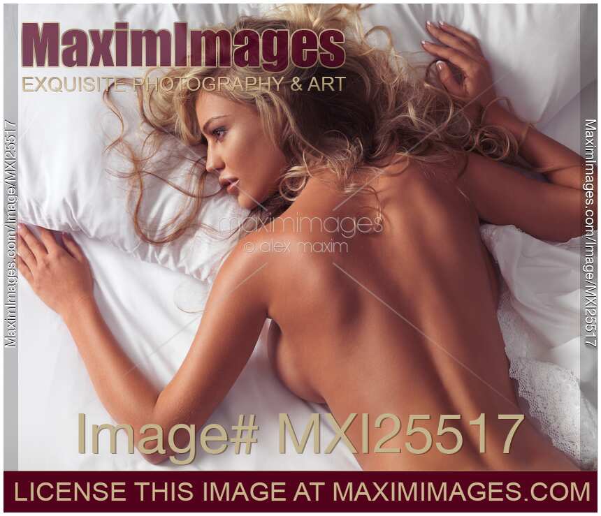 Young woman lying naked in bed Charlie Riina