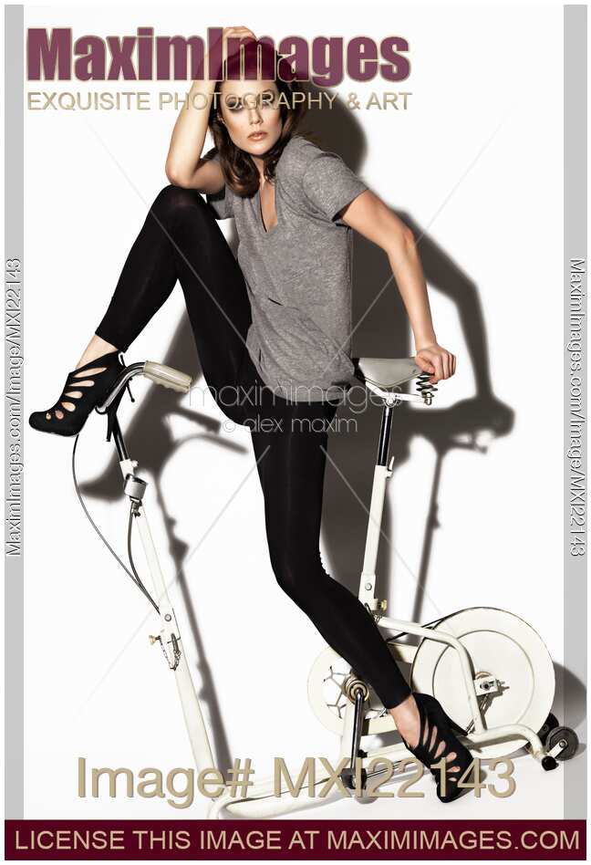 Young Woman On Exercise Bike