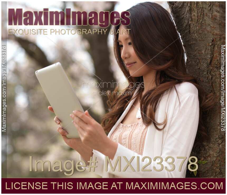 Young Woman Outdoors with a Tablet Computer