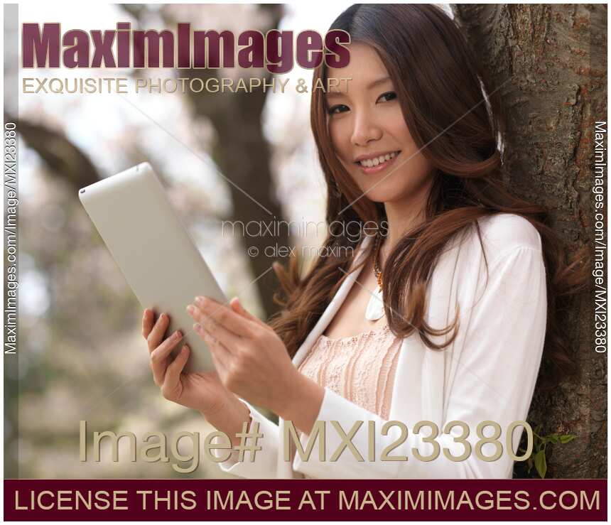 Young Woman Outdoors with a Tablet Computer