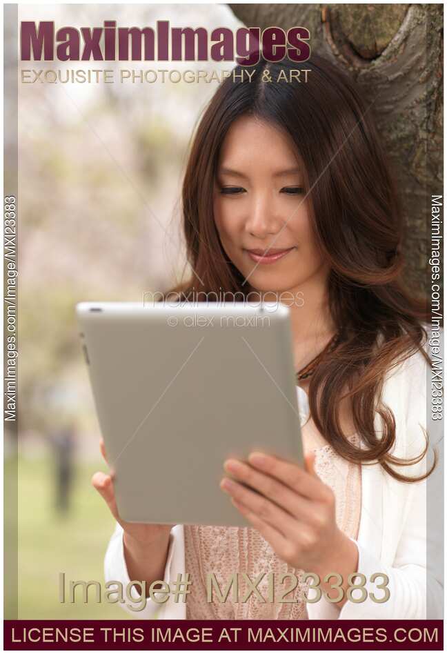 Young Woman Outdoors with a Tablet Computer