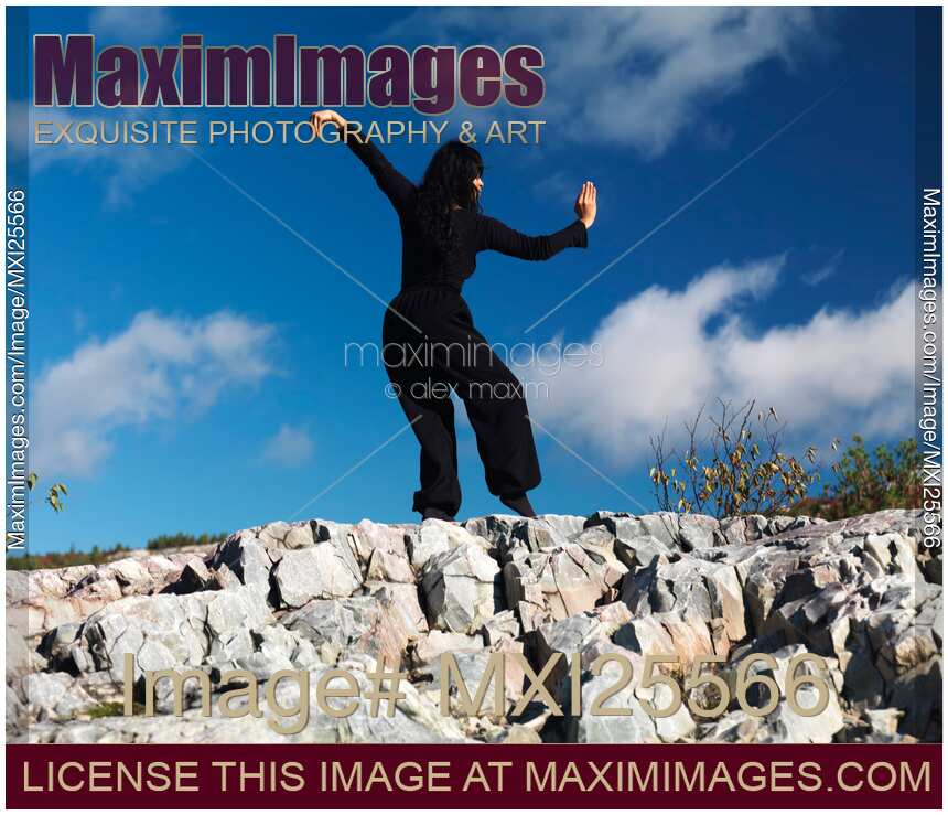Young woman practicing Kung Fu in the nature