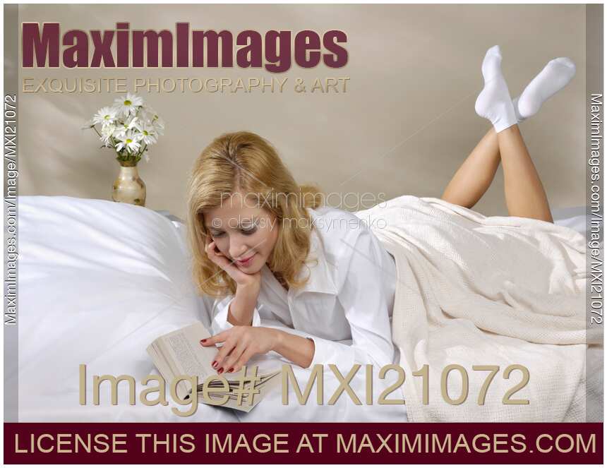 Young Woman Reading in Bed