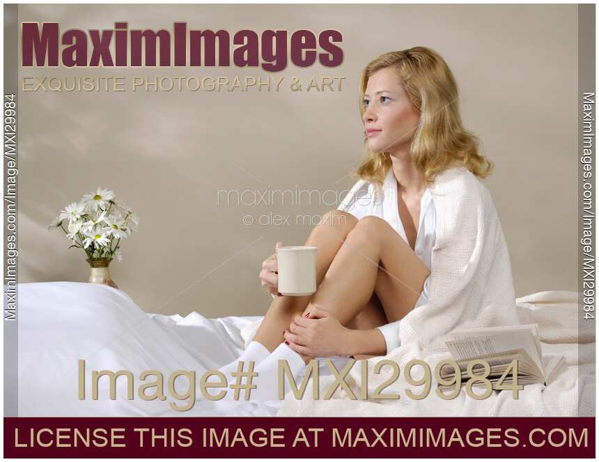 Young Woman Sitting on Bed