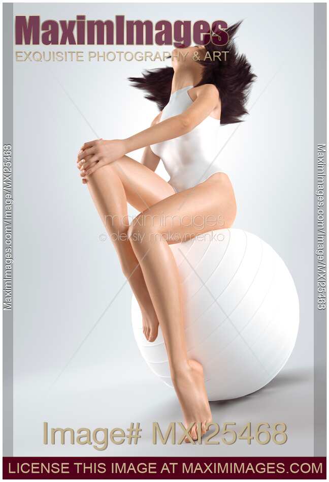 Young woman sitting on white exercise ball