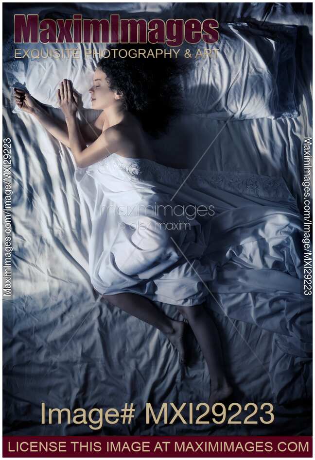 Young woman sleeping in bed at night