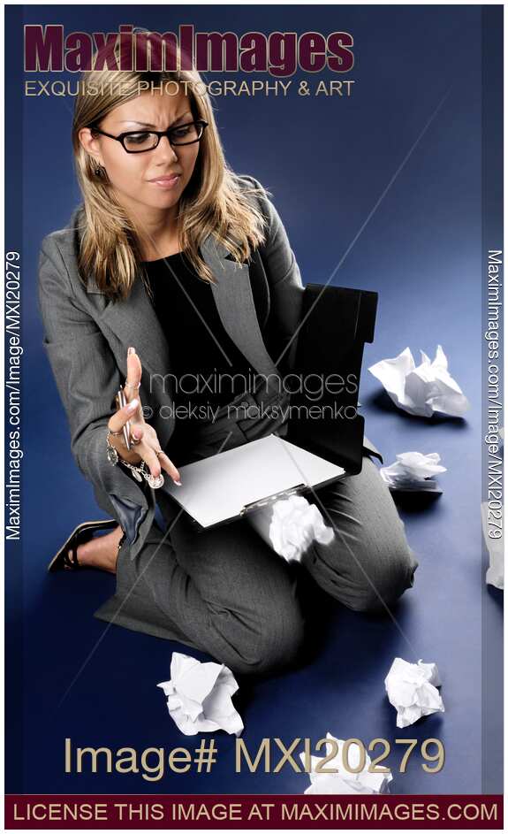 Young woman tossing a crumpled sheet of paper in anger