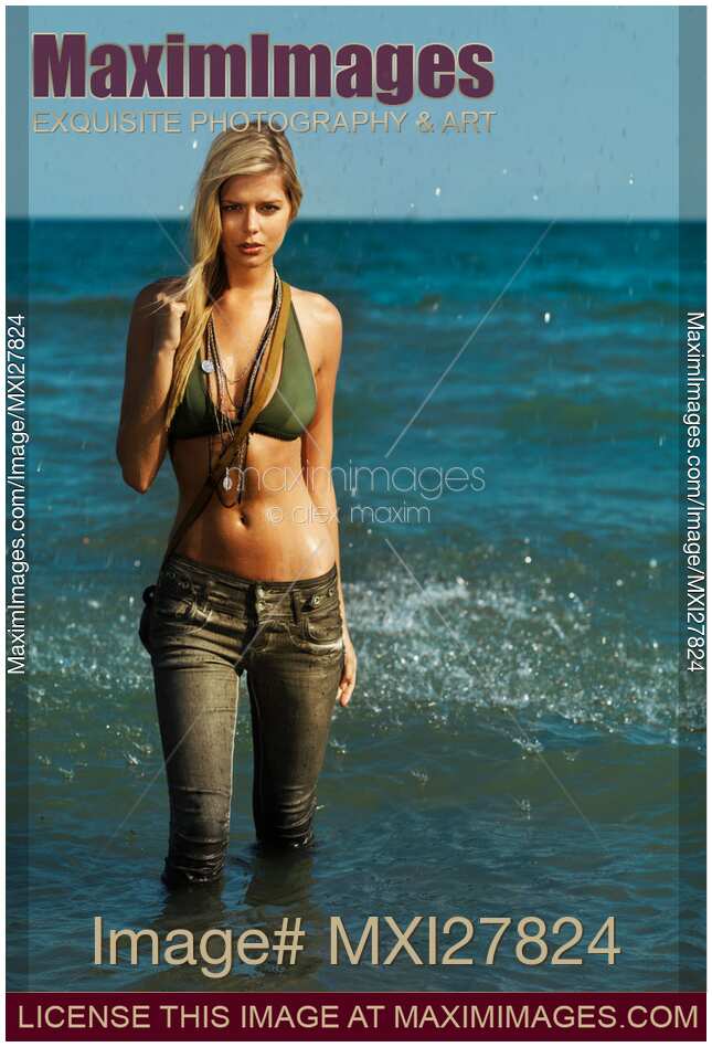 Young woman walking out of water