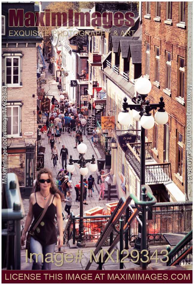 Young woman walking up the stairs of historic street Rue du Petit Champlain of Old Quebec City