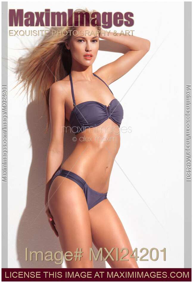 Young woman wearing gray two-piece bikini swimsuit