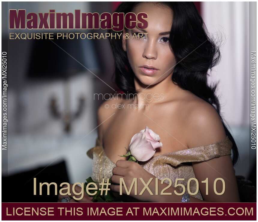 Young woman with a rose dramatic portrait