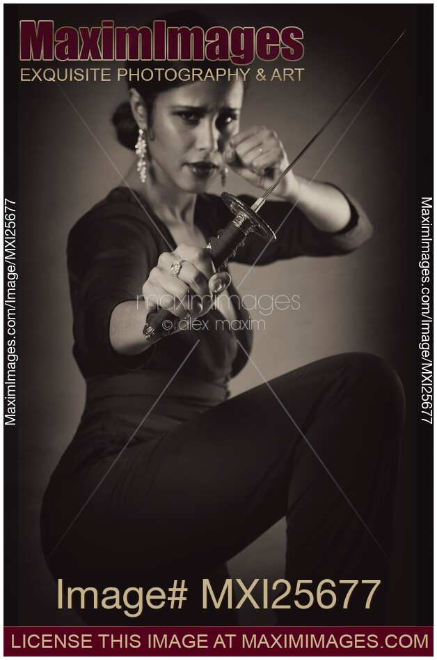 Young woman with knife in defending pose Black and white