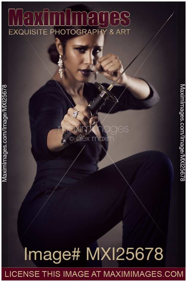 Young woman with knife in defending pose