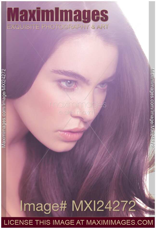 Young woman with long hair in soft light