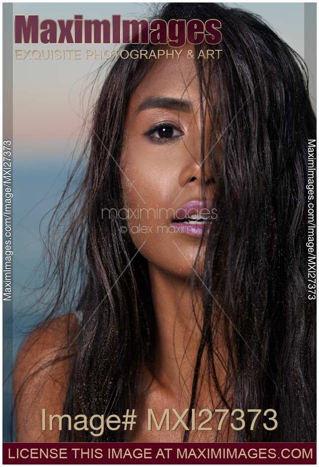 Young woman with long wet hair covering her face