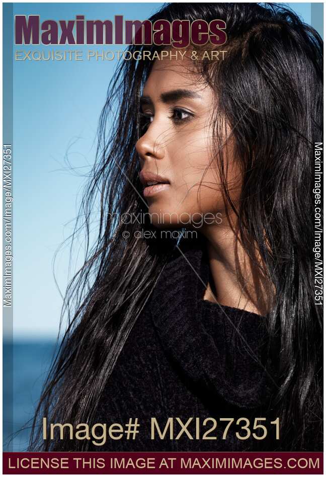 Young woman with long wet hair portrait at the beach