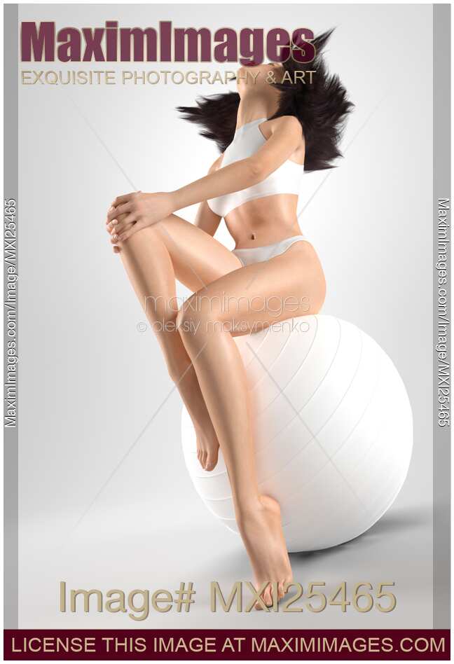 Young woman with slim sit body on fitness ball