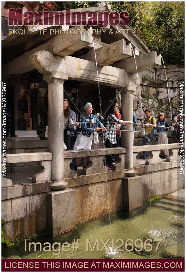 Young women at Otowa-no-taki waterfall at Kiyomizudera Kyoto