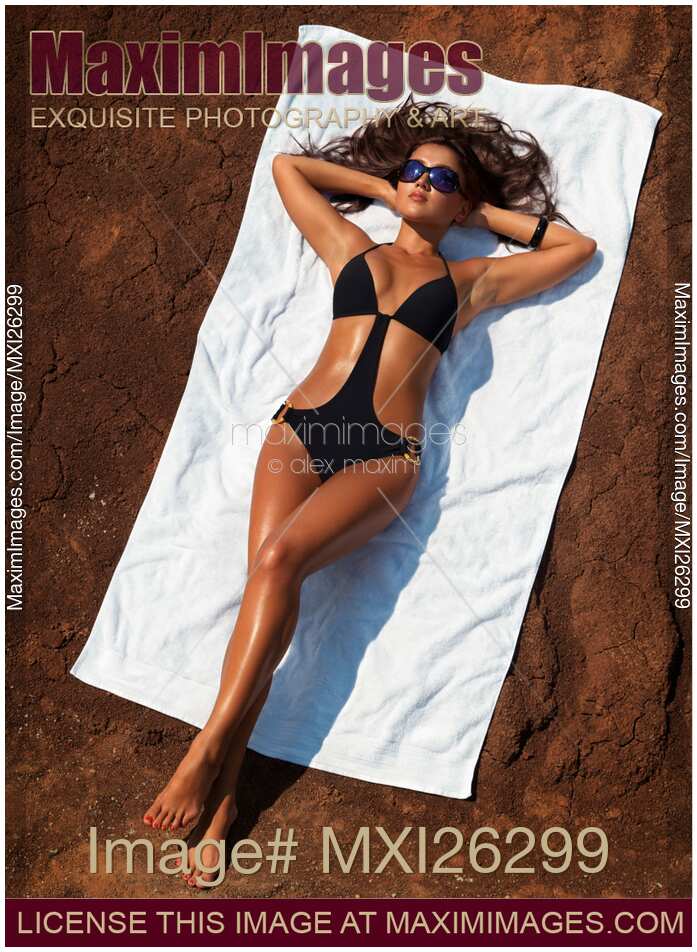 Yuomg sexy woman in swimsuit sunbathing