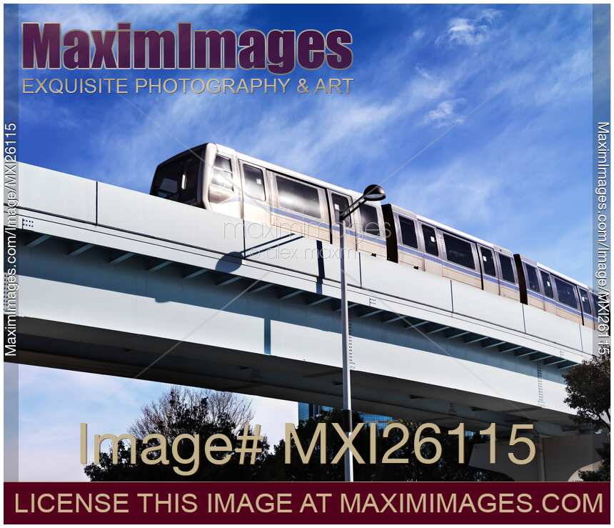 Yurikamome line train on elevated railway going through Odaiba Tokyo