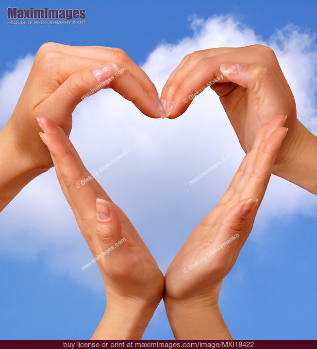 Stock photo of Hands Making Heart over Blue Sky Buy commercial use license at MaximImages