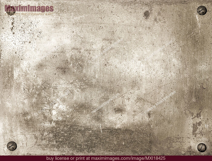 Stock photo of Shiny brass metal plate with screws Buy commercial use license at MaximImages