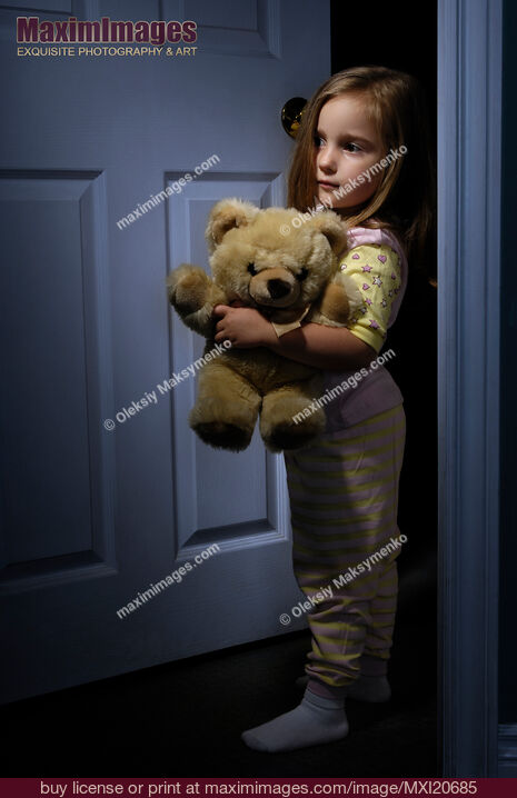 Stock photo of Scared Little Girl Home Alone at Night with a Teddy Bear Buy commercial use license at MaximImages