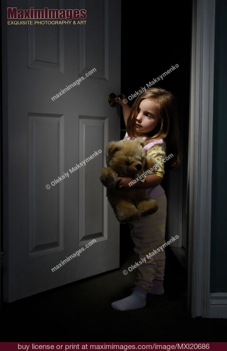 Stock photo of Little Girl Looking out of a Room at Night Buy commercial use license at MaximImages