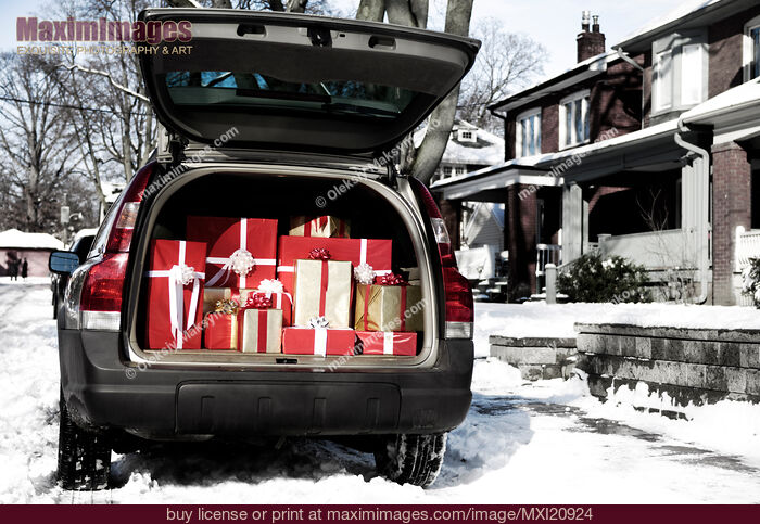 Stock photo of Car with open trunk full of gift boxes Christmas presents Buy commercial use license at MaximImages