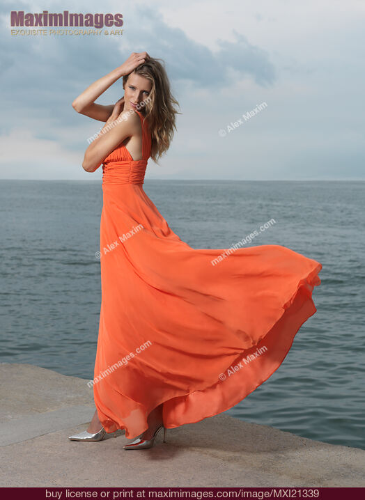 Stock photo of Beautiful Woman on a Sea Shore Buy commercial use license at MaximImages