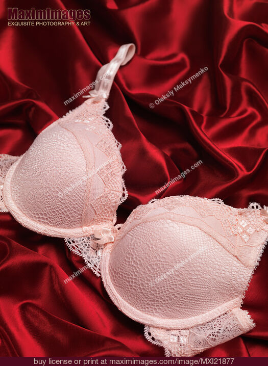 Stock photo of Lacy Bra on Red Silky Fabric Buy commercial use license at MaximImages