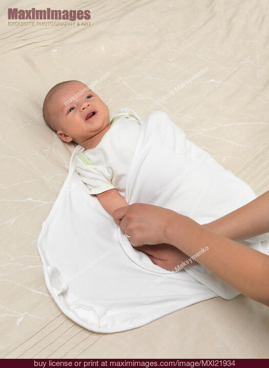 Mother Swaddling a Baby. Stock Photo MXI21934