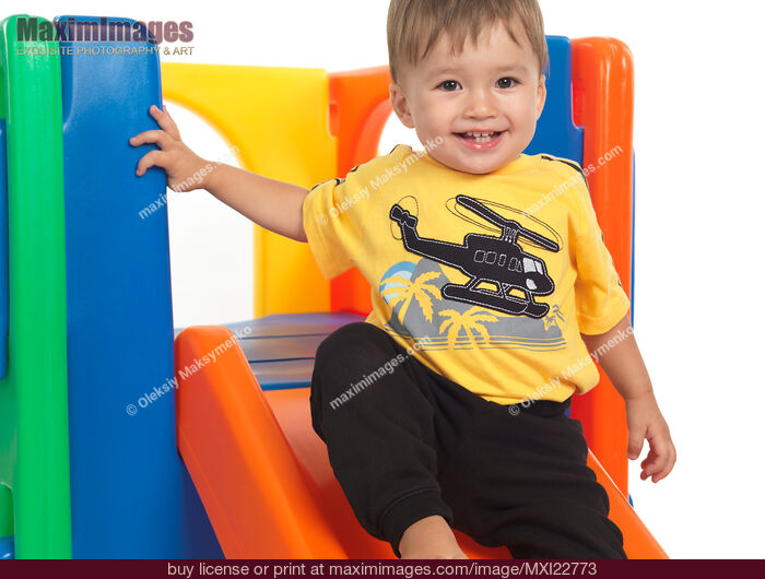 Stock photo of Happy Child on a Slide Buy commercial use license at MaximImages