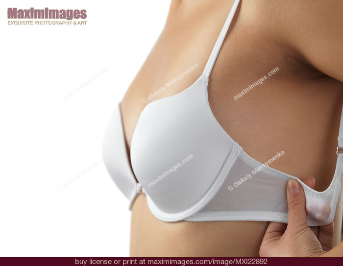 Stock photo of Woman Putting on a Bra Buy commercial use license at MaximImages