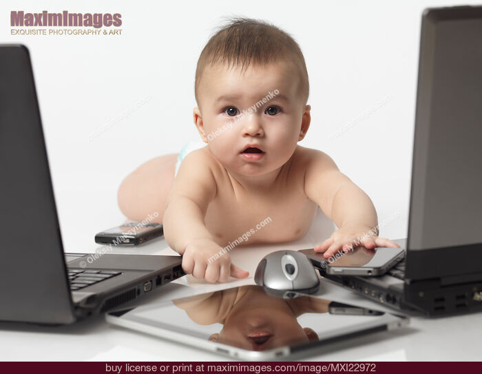 Stock photo of Baby amongst Computers and Electronics Buy commercial use license at MaximImages