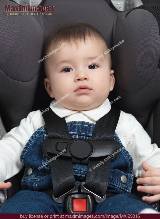 Baby in a Booster Seat. Stock Photo MXI23016